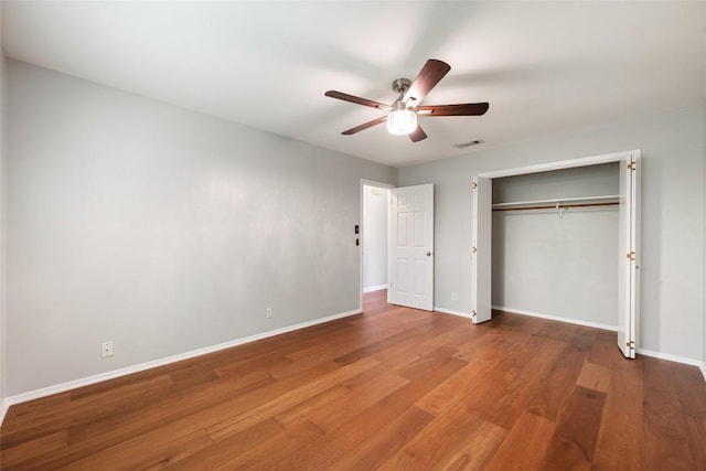 8500 Woodstone Dr, Austin, TX 78757 - unfurnished bedroom with wood finished floors, a closet, and ceiling fan