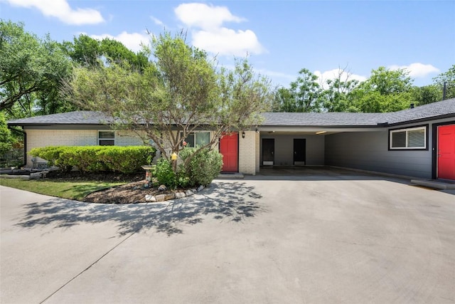 8500 Woodstone Dr, Austin, TX 78757 - single story home with a carport, asphalt driveway, and brick siding