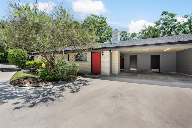 8500 Woodstone Dr, Austin, TX 78757 - ranch-style home featuring brick siding, driveway, a chimney, and a carport