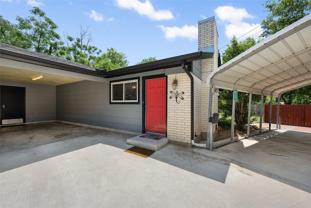 8500 Woodstone Dr, Austin, TX 78757 - property entrance featuring a chimney, fence, brick siding, and concrete driveway