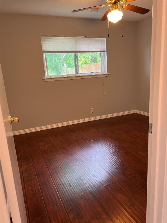 8500 Woodstone Dr, Austin, TX 78757 - empty room featuring dark wood-style floors and ceiling fan