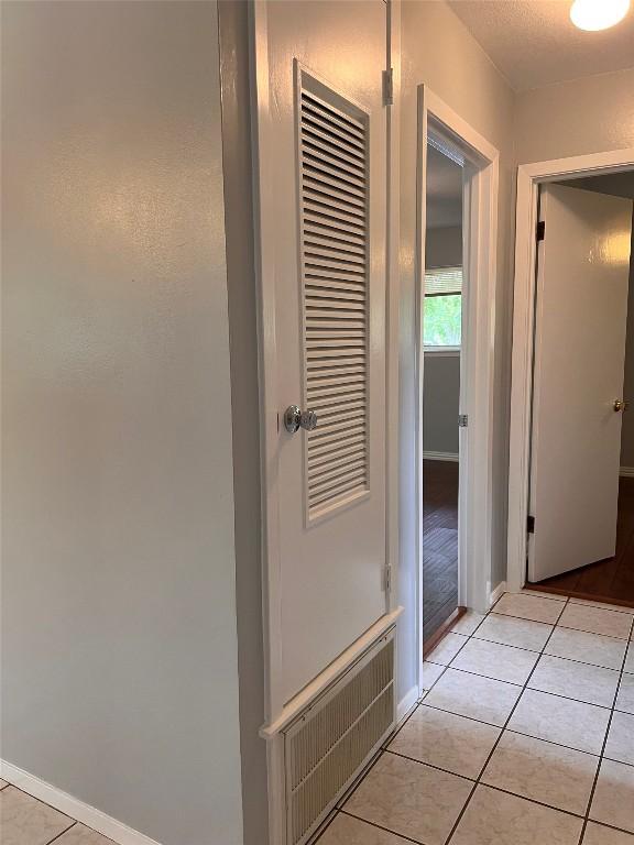 8500 Woodstone Dr, Austin, TX 78757 - corridor with baseboards and light tile patterned floors