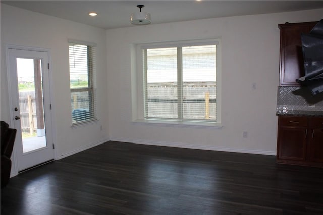 352 Cherrystone Loop, Buda, TX 78610 - unfurnished dining area with dark wood-style floors, baseboards, and recessed lighting