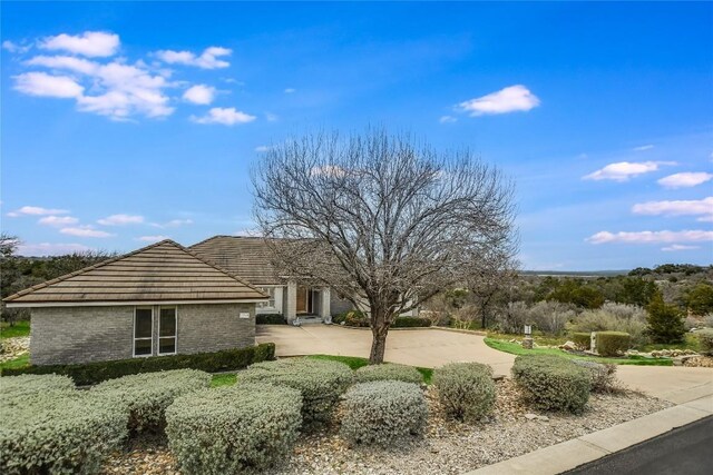 1310 Clayton Nolen, Horseshoe Bay, TX 78657 - view of front of house with curved driveway and brick siding