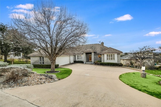 1310 Clayton Nolen, Horseshoe Bay, TX 78657 - view of front facade with curved driveway, an attached garage, a chimney, and a front lawn