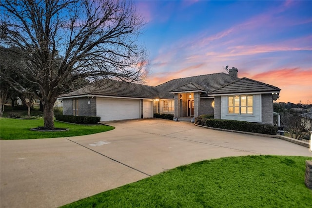 1310 Clayton Nolen, Horseshoe Bay, TX 78657 - view of front of property featuring concrete driveway, a garage, a yard, a chimney, and brick siding