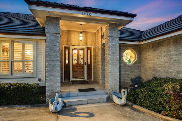 1310 Clayton Nolen, Horseshoe Bay, TX 78657 - doorway to property featuring brick siding