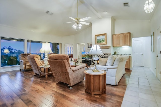 1310 Clayton Nolen, Horseshoe Bay, TX 78657 - living room with high vaulted ceiling, hardwood / wood-style floors, a ceiling fan, and beamed ceiling