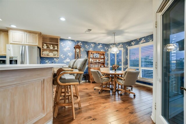 1310 Clayton Nolen, Horseshoe Bay, TX 78657 - dining area featuring wallpapered walls, light wood finished floors, recessed lighting, and a chandelier