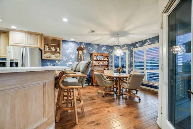 1310 Clayton Nolen, Horseshoe Bay, TX 78657 - dining area with wallpapered walls, light wood-type flooring, a chandelier, and recessed lighting
