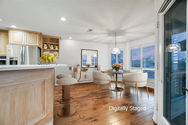 1310 Clayton Nolen, Horseshoe Bay, TX 78657 - dining area featuring wood-type flooring, recessed lighting, and a baseboard heating unit