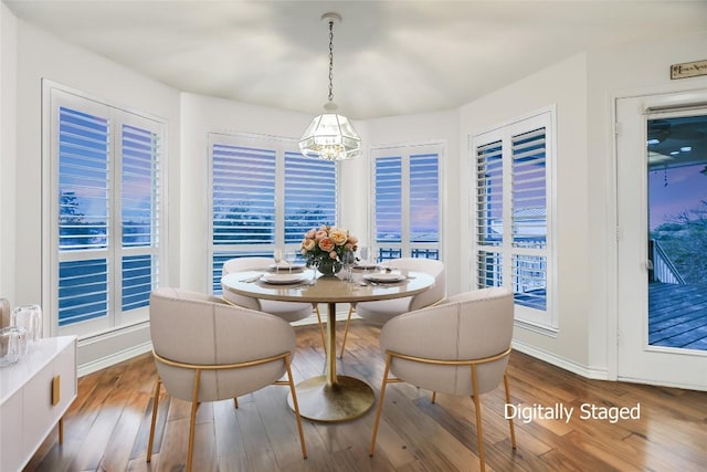 1310 Clayton Nolen, Horseshoe Bay, TX 78657 - dining room with wood finished floors, a chandelier, and baseboards