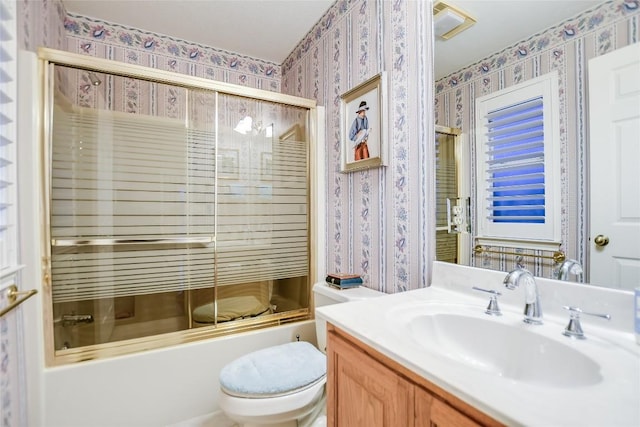 1310 Clayton Nolen, Horseshoe Bay, TX 78657 - bathroom with wallpapered walls, vanity, toilet, and shower / bath combination with glass door
