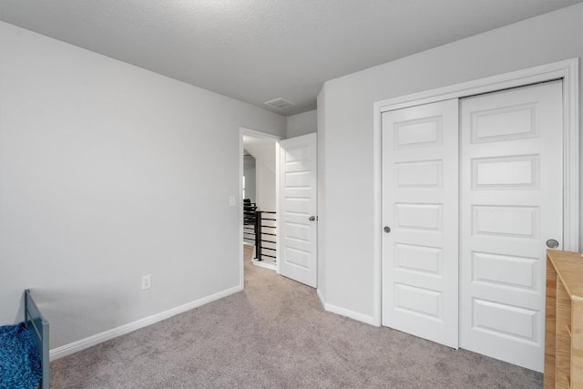 224 Backstays Loop, Kyle, TX 78640 - unfurnished bedroom featuring carpet, baseboards, and a closet