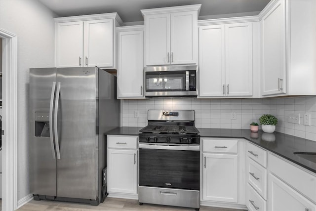 224 Backstays Loop, Kyle, TX 78640 - kitchen featuring appliances with stainless steel finishes, tasteful backsplash, and dark countertops