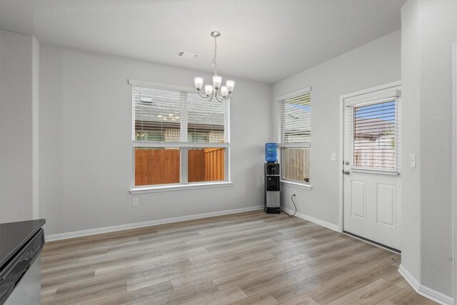 224 Backstays Loop, Kyle, TX 78640 - unfurnished dining area with light wood-style flooring, a chandelier, and baseboards