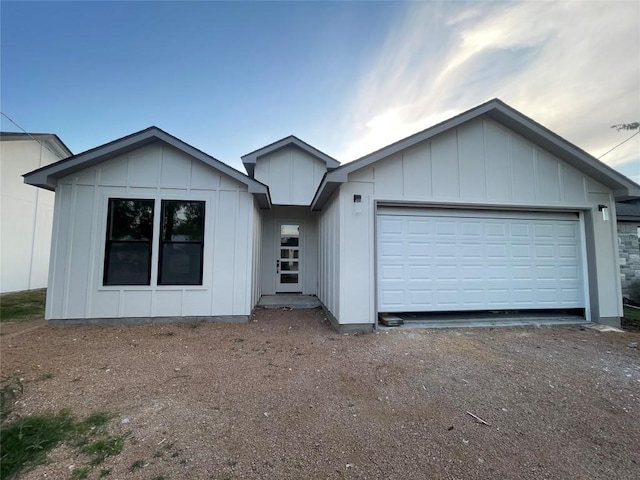 650 Birch Ln, Cottonwood Shores, TX 78657 - view of front of home featuring board and batten siding, an attached garage, and driveway