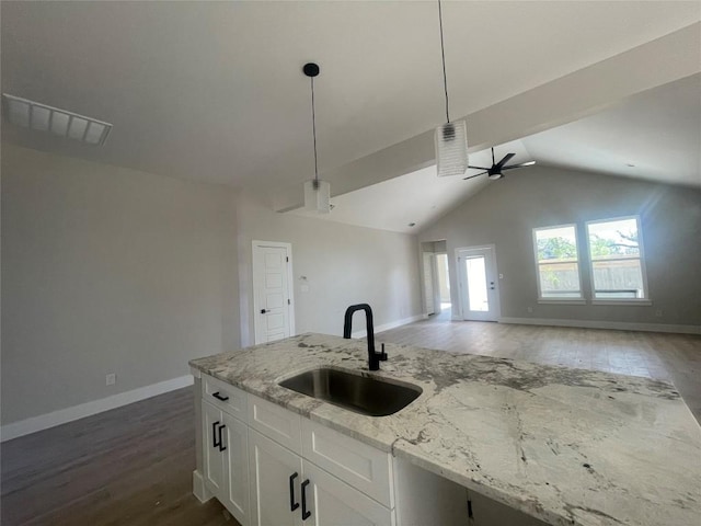 650 Birch Ln, Cottonwood Shores, TX 78657 - kitchen with a sink, open floor plan, dark wood finished floors, baseboards, and vaulted ceiling