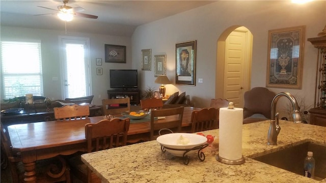 5301 Ponte Tresa Dr, Bee Cave, TX 78738 - living area with arched walkways, a ceiling fan, and lofted ceiling