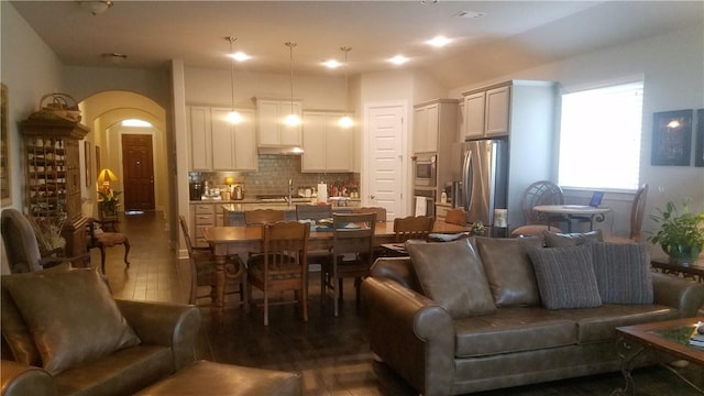 5301 Ponte Tresa Dr, Bee Cave, TX 78738 - living room with dark wood-style floors and arched walkways
