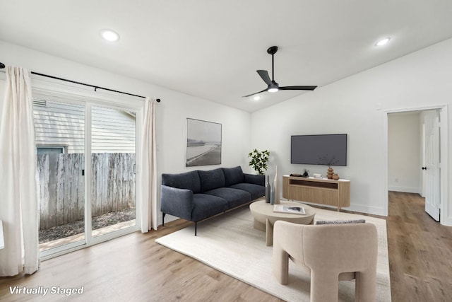 living room with lofted ceiling, a ceiling fan, wood finished floors, recessed lighting, and baseboards