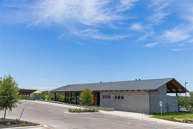 1821 Plum Tree Way, Georgetown, TX 78628 - view of front facade featuring a standing seam roof, metal roof, and stone siding