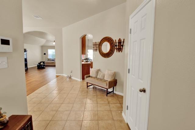 1040 Kensington Castle Trl, Pflugerville, TX 78660 - hallway with arched walkways and light tile patterned floors