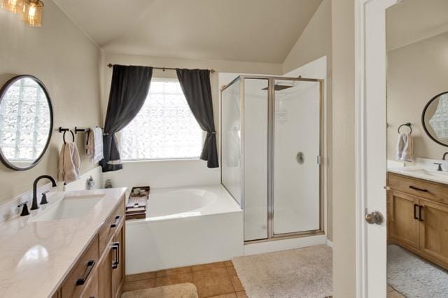 1040 Kensington Castle Trl, Pflugerville, TX 78660 - full bath with vaulted ceiling, a shower stall, a garden tub, vanity, and tile patterned floors