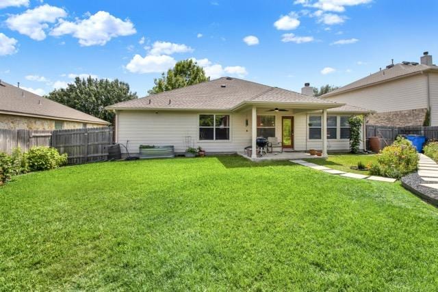 1040 Kensington Castle Trl, Pflugerville, TX 78660 - back of house with ceiling fan, a fenced backyard, and a patio area