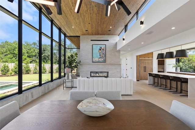 1604 Barclay Dr, Austin, TX 78746 - dining room with a towering ceiling, a fireplace, a ceiling fan, wooden ceiling, and recessed lighting