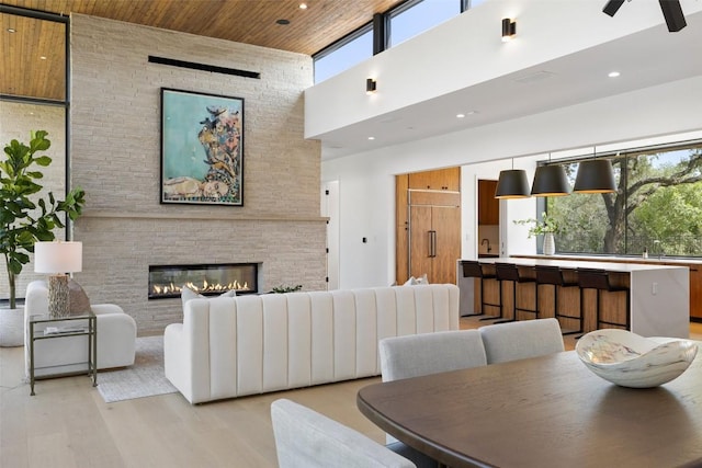 1604 Barclay Dr, Austin, TX 78746 - dining space with a towering ceiling, light wood-type flooring, a fireplace, recessed lighting, and ceiling fan