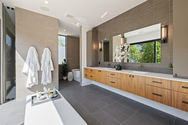 1604 Barclay Dr, Austin, TX 78746 - bathroom with double vanity, tile patterned floors, tile walls, tasteful backsplash, and recessed lighting