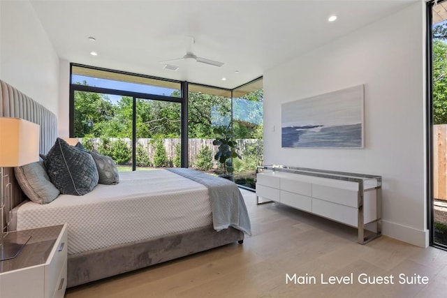 1604 Barclay Dr, Austin, TX 78746 - bedroom featuring floor to ceiling windows, light wood finished floors, recessed lighting, and access to outside