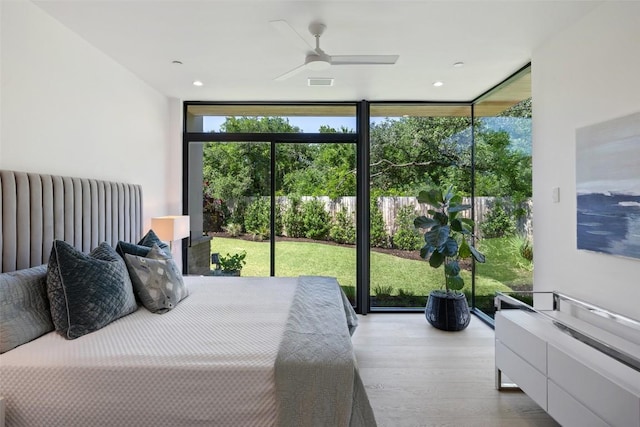 1604 Barclay Dr, Austin, TX 78746 - bedroom featuring expansive windows, wood finished floors, radiator heating unit, and a ceiling fan