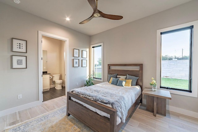 bedroom with light wood-type flooring, baseboards, ensuite bathroom, recessed lighting, and a ceiling fan