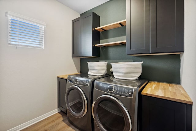1116 View Dr, Georgetown, TX 78628 - washroom featuring cabinet space, washing machine and clothes dryer, and light wood-type flooring