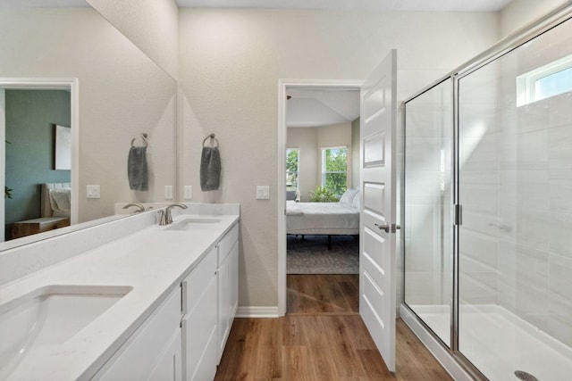 1116 View Dr, Georgetown, TX 78628 - ensuite bathroom with wood finished floors, plenty of natural light, double vanity, and a shower stall
