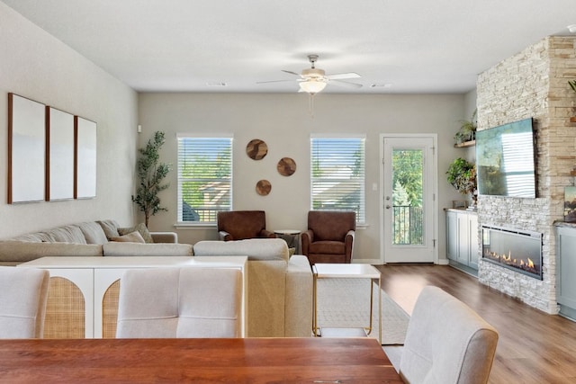 1116 View Dr, Georgetown, TX 78628 - living room with wood finished floors, a ceiling fan, and a fireplace
