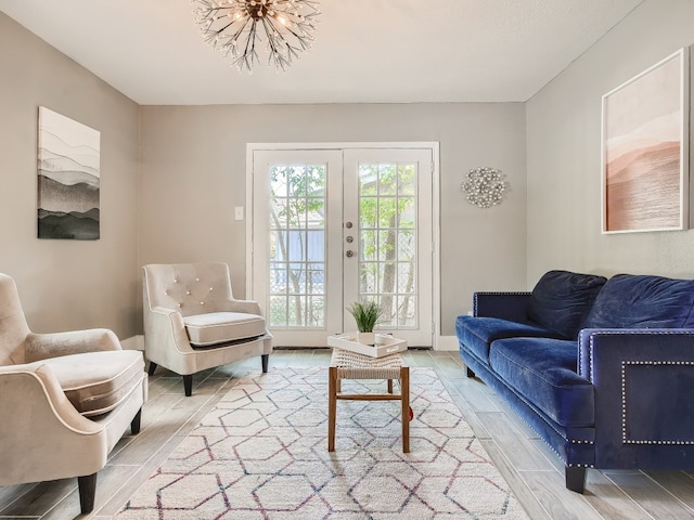 living room with wood finished floors, french doors, and baseboards
