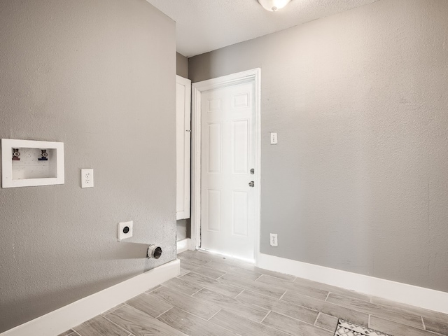 washroom featuring hookup for an electric dryer, hookup for a washing machine, wood finish floors, and baseboards