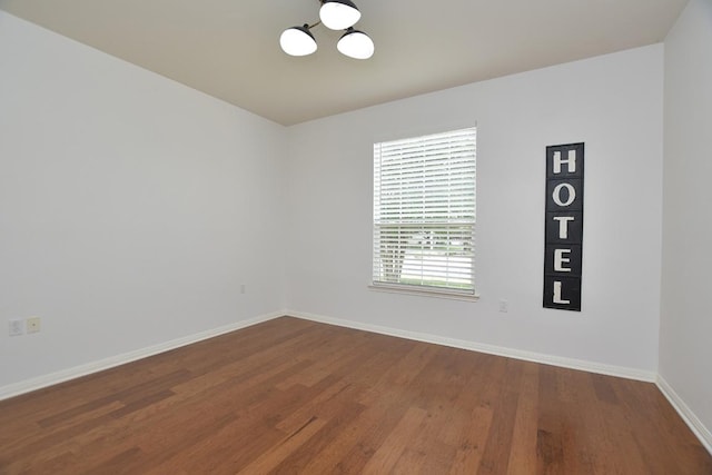 101 Scurry Pass, Georgetown, TX 78633 - spare room with a chandelier and dark wood-type flooring