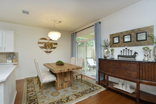 101 Scurry Pass, Georgetown, TX 78633 - dining room featuring dark wood finished floors, ornamental molding, and a chandelier