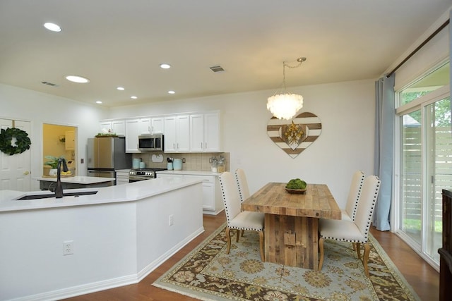 101 Scurry Pass, Georgetown, TX 78633 - dining space featuring a chandelier, dark wood finished floors, and recessed lighting