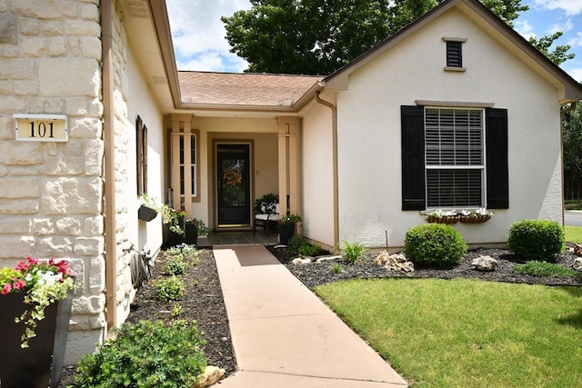 101 Scurry Pass, Georgetown, TX 78633 - view of exterior entry featuring stucco siding, a yard, and stone siding