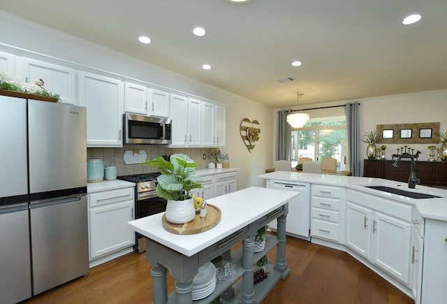 101 Scurry Pass, Georgetown, TX 78633 - kitchen featuring stainless steel appliances, light countertops, white cabinets, decorative backsplash, and decorative light fixtures