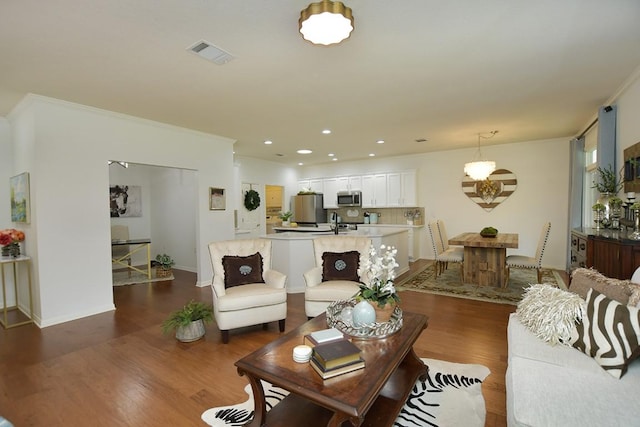 101 Scurry Pass, Georgetown, TX 78633 - living area with wood finished floors, crown molding, recessed lighting, and baseboards
