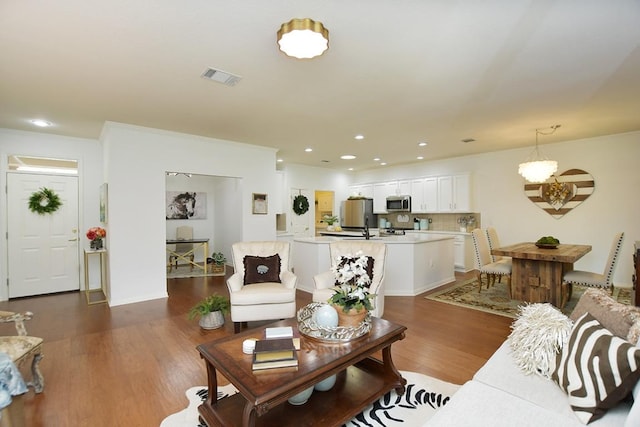 101 Scurry Pass, Georgetown, TX 78633 - living room with wood finished floors, recessed lighting, and a chandelier