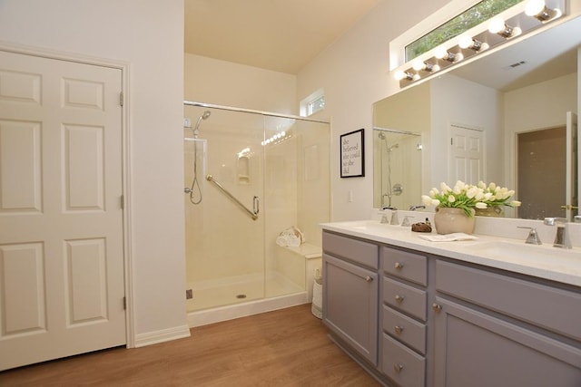 101 Scurry Pass, Georgetown, TX 78633 - full bath with a shower stall, double vanity, and wood finished floors