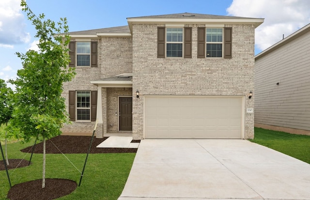 view of front facade featuring concrete driveway, an attached garage, brick siding, and a front lawn
