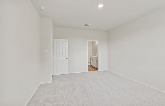 spare room with light carpet, baseboards, and recessed lighting